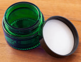 (12 Pack) 1 oz Green Glass Thick Wall Balm Jars with Black Smooth Foam Lined Lids