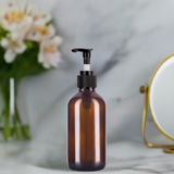 (12 pack) 8 oz Amber Boston Round Glass Bottle with Black Lotion Pump and Phenolic Cap - JUVITUS