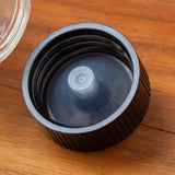 Amber Glass Boston Round Bottle with Airtight Phenolic Cap (12 Pack) - JUVITUS